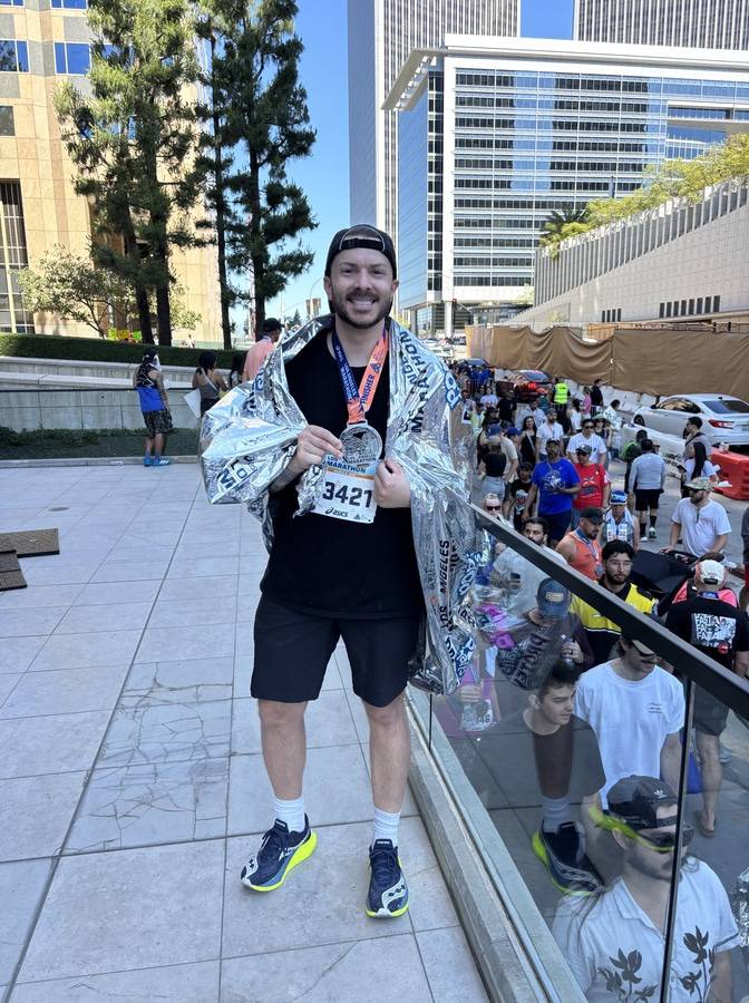 Kenny Lopez at the finish line after finishing a marathon.