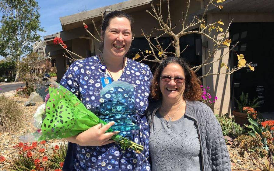 Two Scripps hospice nurses smile after receiving the CARE award by CBS Radio.