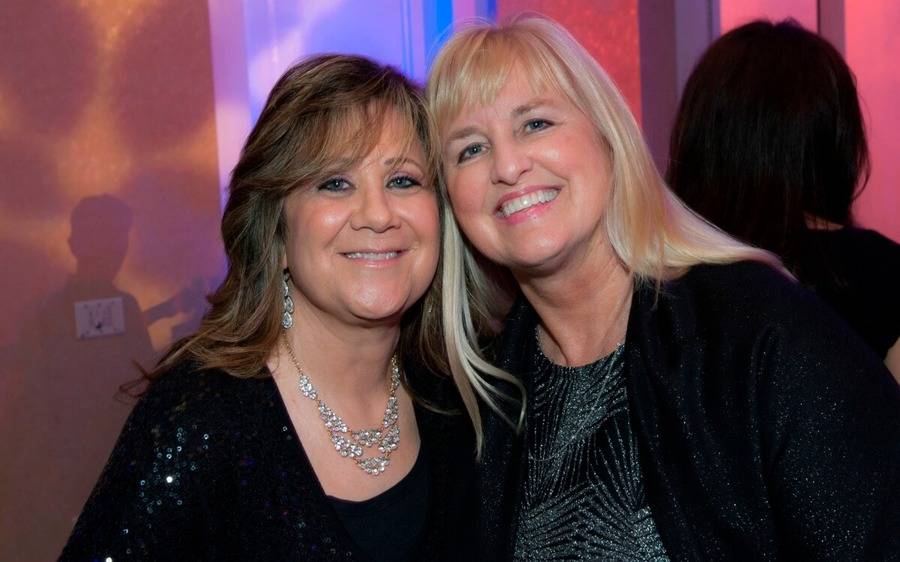 Two mature women enjoy a fun evening at the 26th Annual Spinoff Gala.