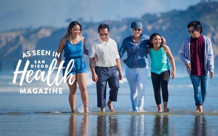 Angela Flores splashes her feet in the ocean with her family, after lung cancer treatment at Scripps MD Anderson Cancer Center in San Diego.