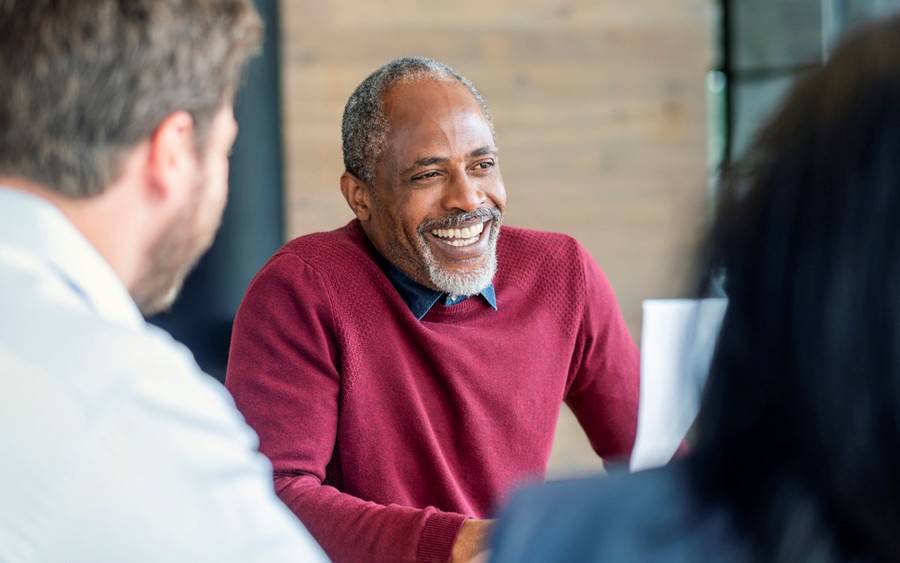 An older African-American man discusses symptoms of male menopause, another name for low-testosterone, with his physician.