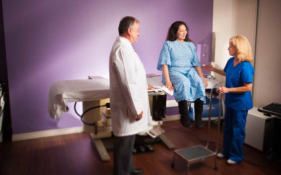 A Scripps patient has a conversation with her physicians about the importance of mammograms in a clinical setting.
