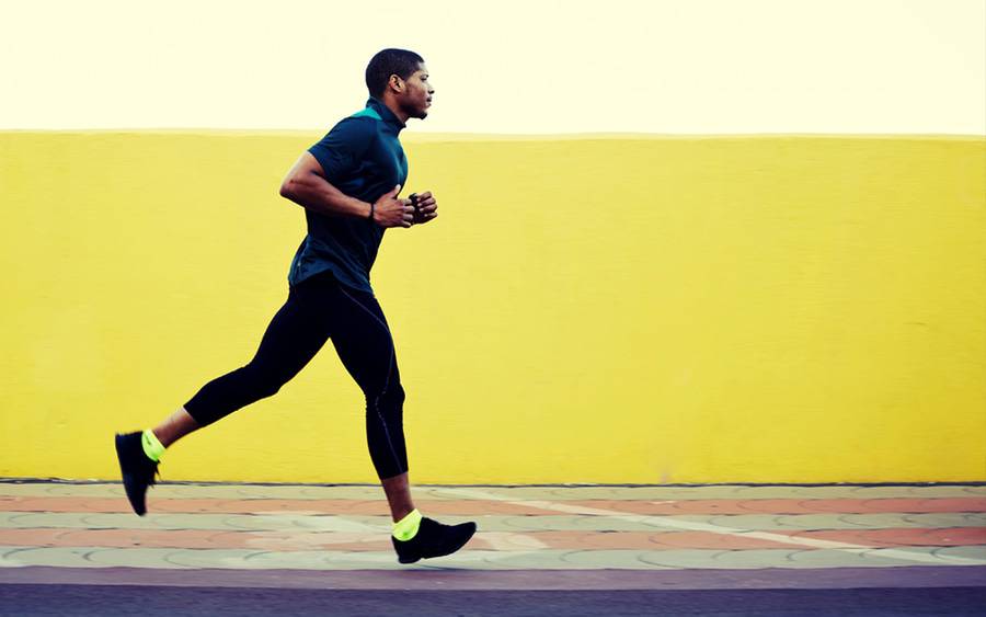 Young man jogging illustrates self-care strategy for staying healthy.