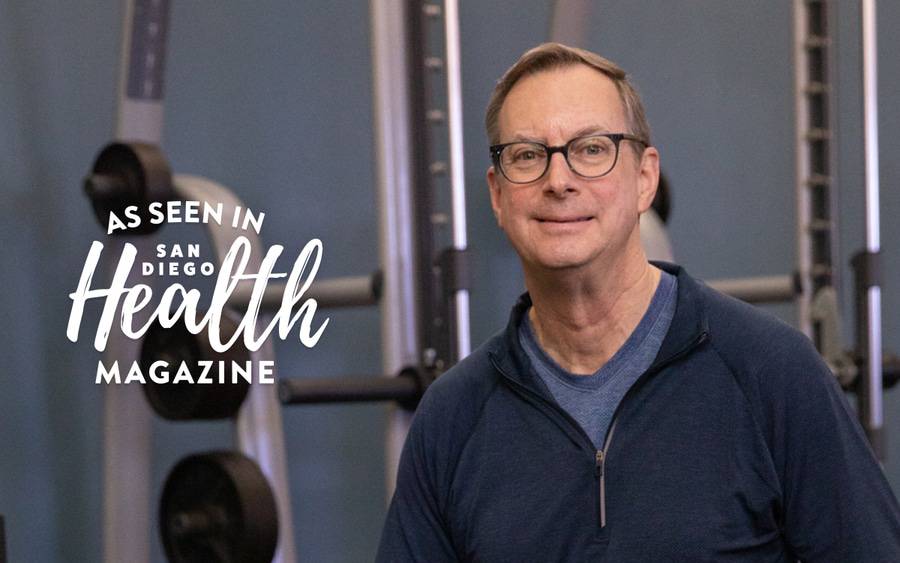 Keith Kendrick, an integrative heart patient sitting in front of gym equipment.