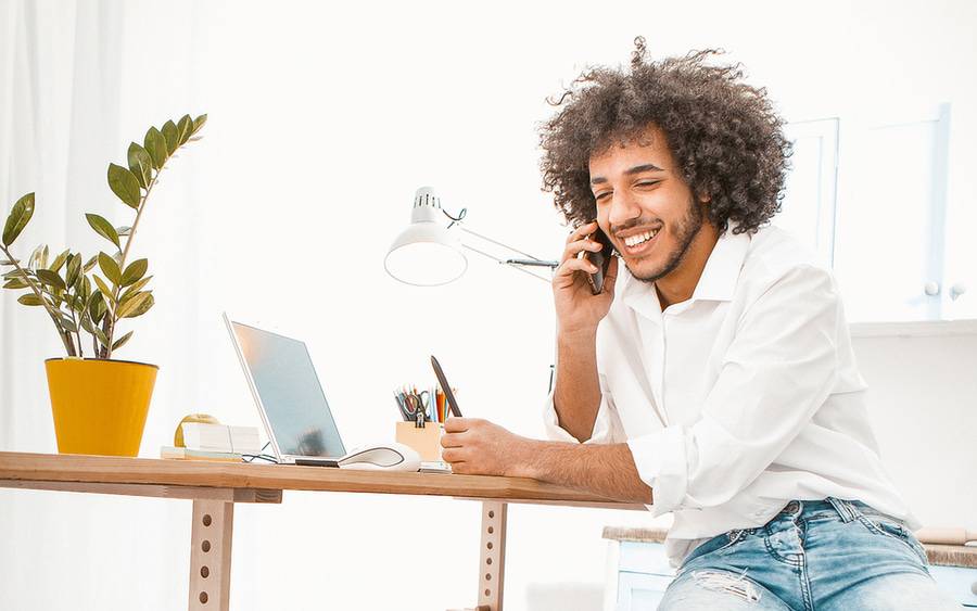 A man working at this desk in an at hoem office.
