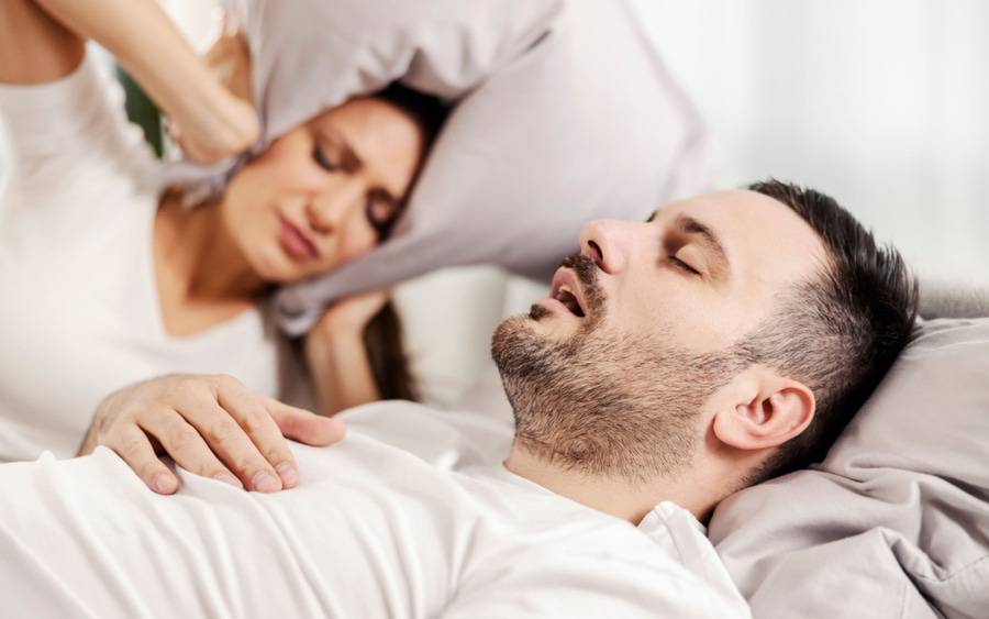 A man with sleep apnea snores at night. His wife can't sleep.