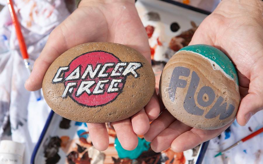 Mark DeSalvo shows off his painted rocks now on display at Scripps MD Anderson - SD Health Magazine