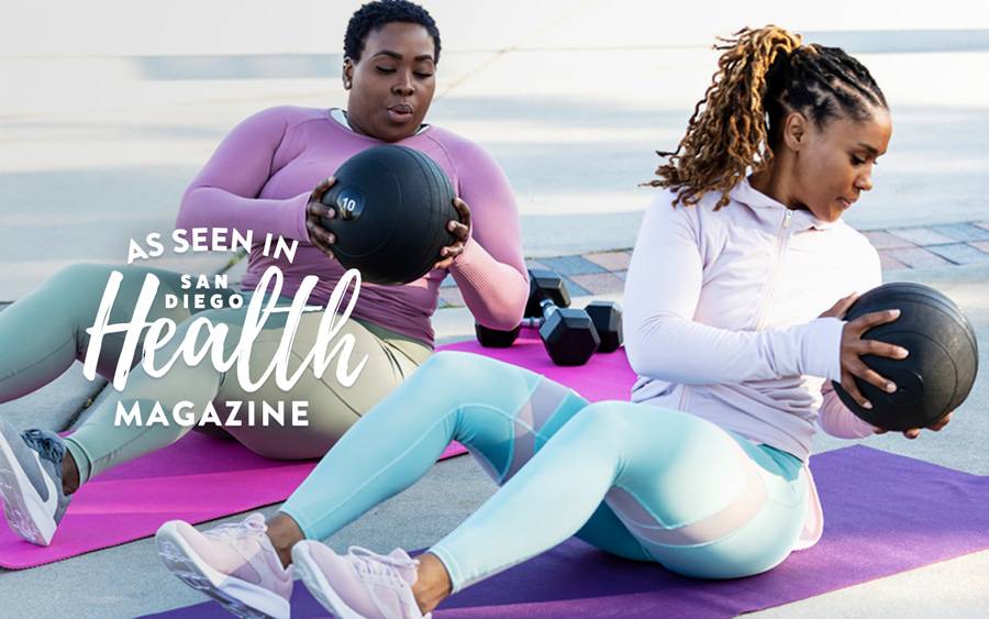 Two women participate in an exercise routine, motivating each other to continue exercising.