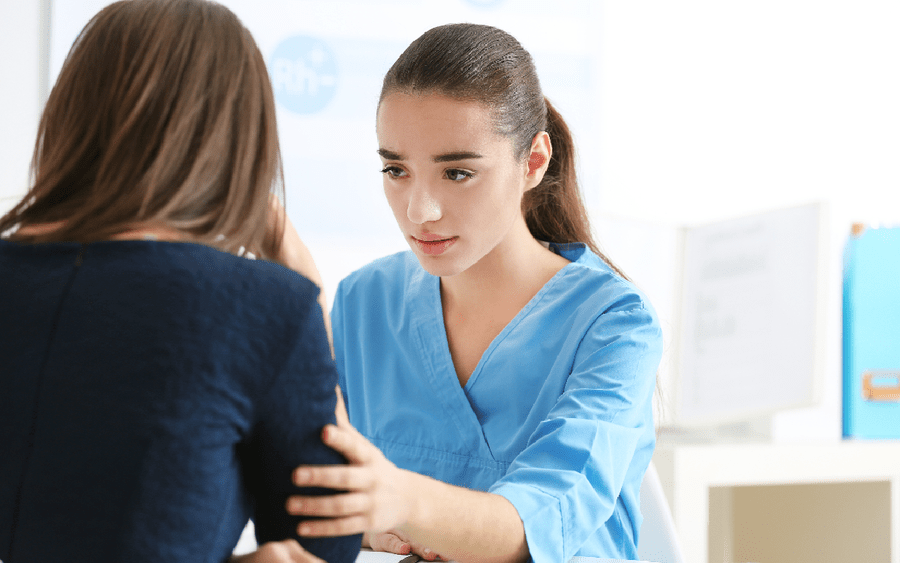 A woman with mental illness is counseled by a nurse.