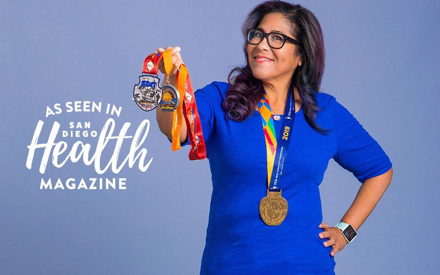 Michelle Feliciano holding her marathon medals illustrating a Scripps Health Bariatric Surgery success patient story.