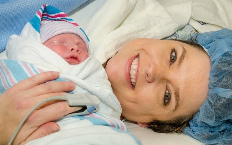 A mother and her infant post-delivery as Scripps Mercy was recognized for reaching its national C-section goal early.
