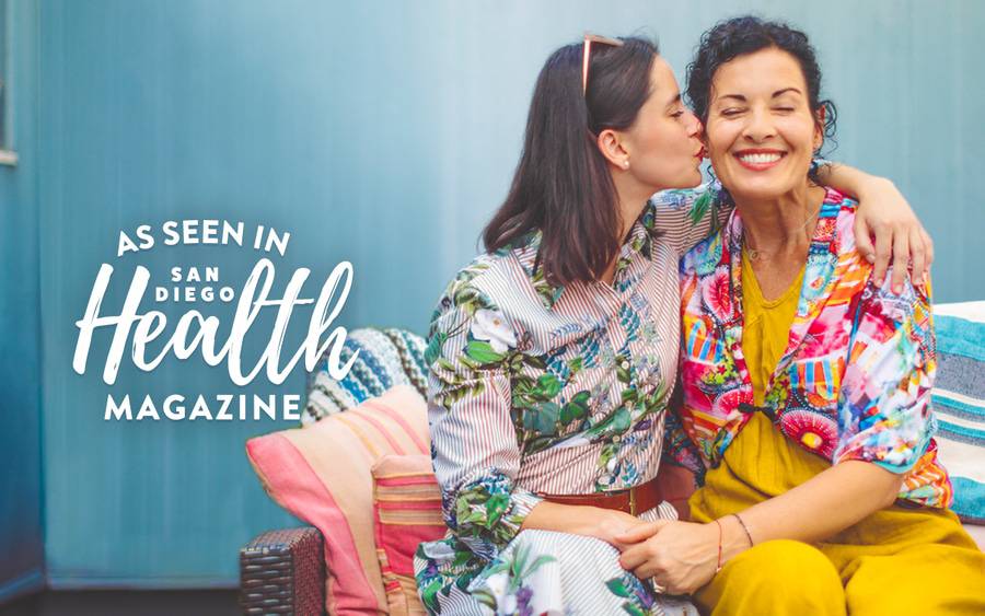 A woman kisses her mother on the cheek, illustrating how the best Mother’s Day gifts express gratitude while boosting happiness and well-being.