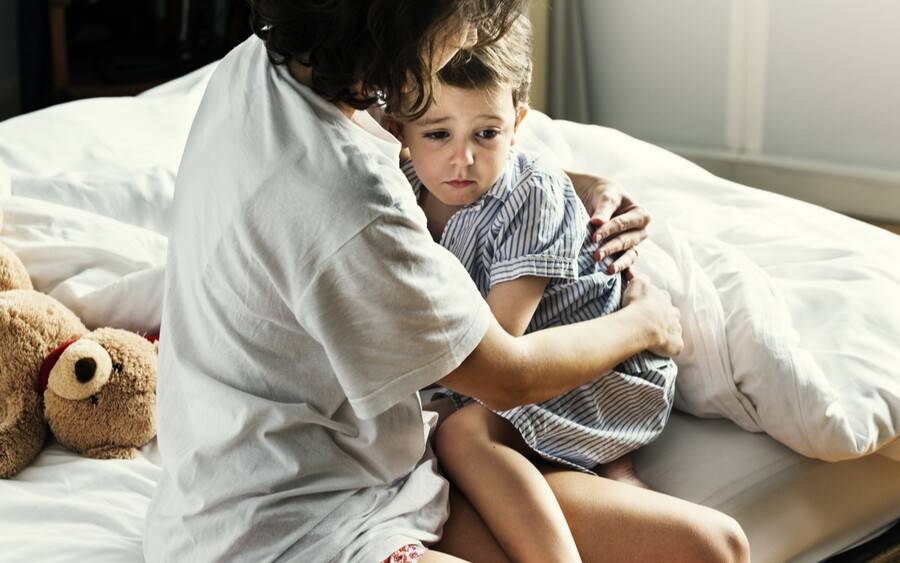 A mother comforts her child after he woke up from a possible nightmare or night terror.