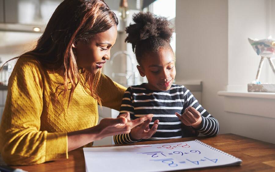 A father and son work on homework together