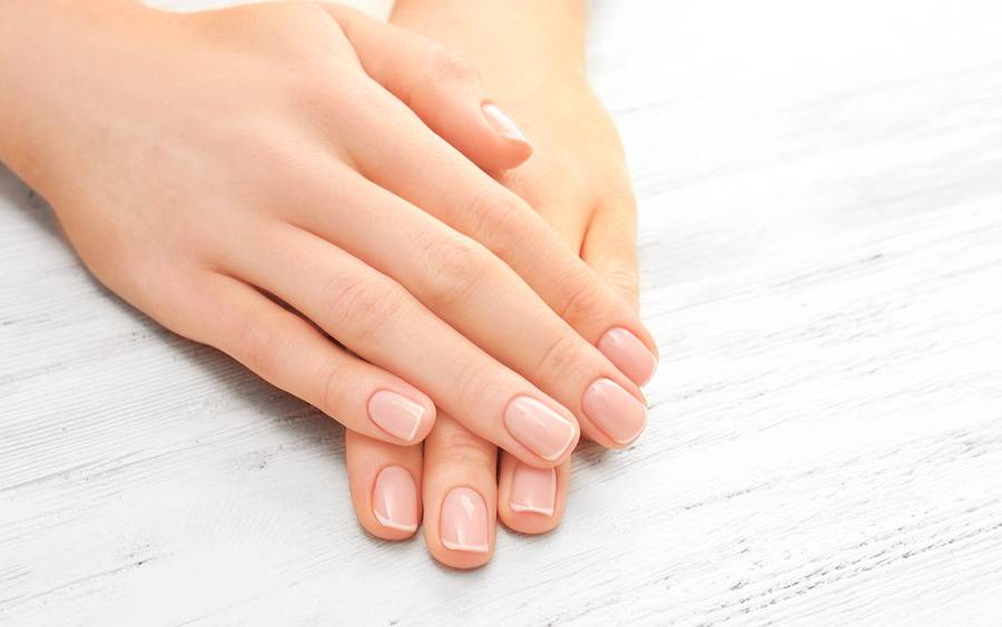 A pair of hands  with nails ready to be examined for any signs of health issues.