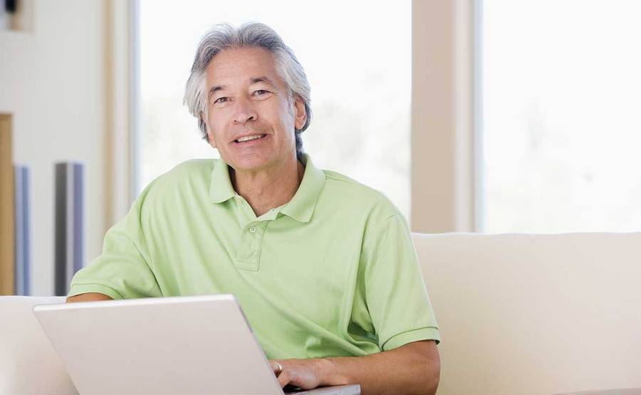 A smiling middle-aged Asian man represents the full life that can be led after nasopharyngeal cancer treatment.