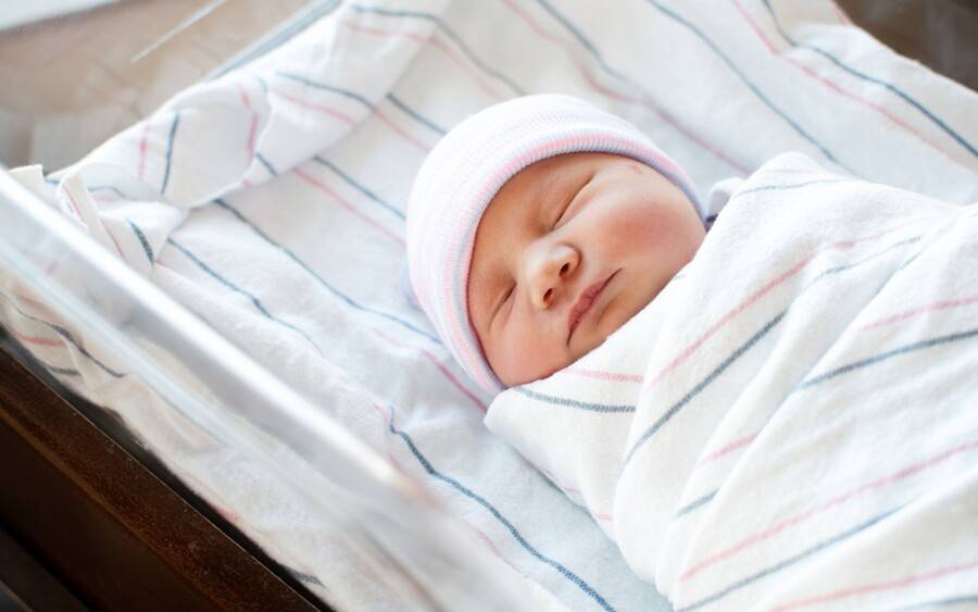 A newborn after receiving vitamin K shot and eye ointment to prevent health issues in first few days, weeks, months of life.