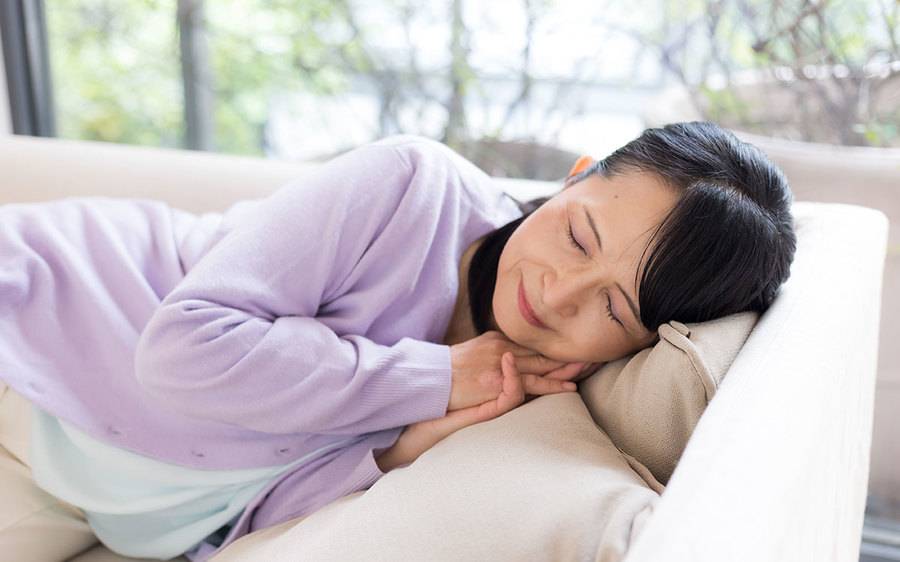 A woman sleeping on a couch.