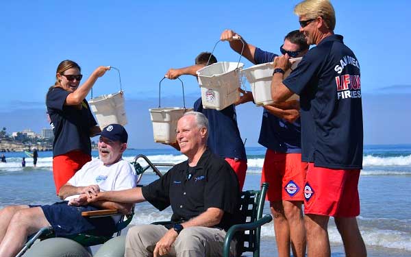 Former Scripps employee, John Boucher, has ALS and is now a patient in Scripps Hospice met with Scripps President and CEO, Chris Van Gorder, to take the Ice Bucket Challenge at La Jolla Shores.
