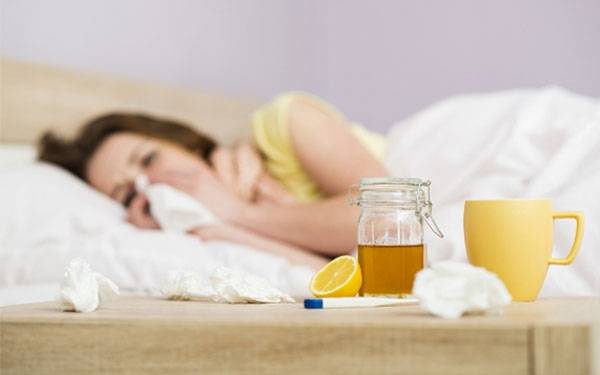 Women with flu getting rest in bed.