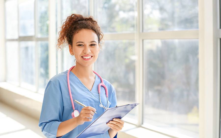 A young smiling physician assistant or nurse practitioner is ready to see you.