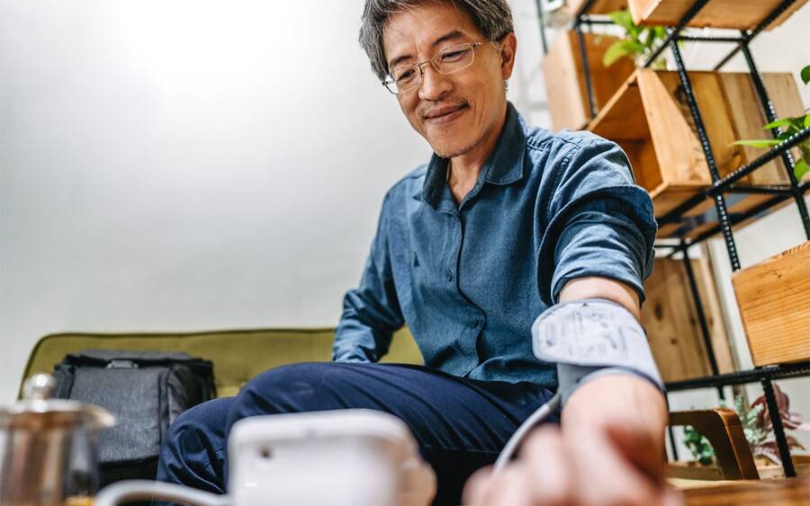 An older man with hypertension gets his blood pressure checked.