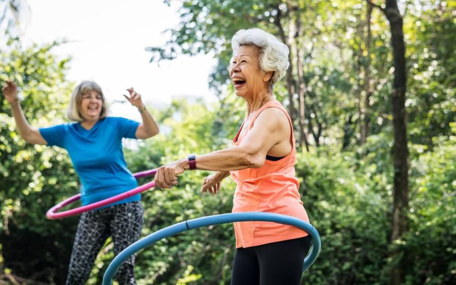 An older woman works on her balance to reduce the risk of falling as she ages.