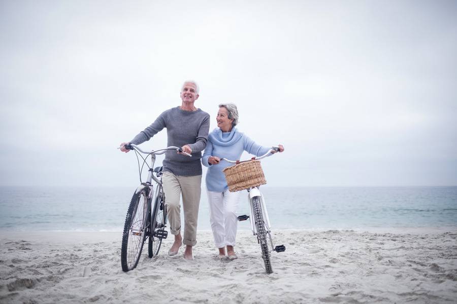 couple with bikes on the beach
