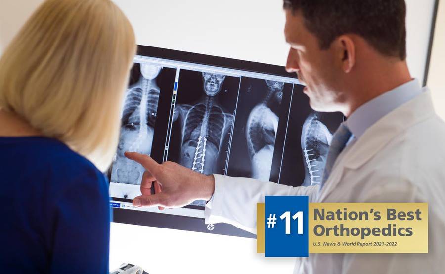 Scripps spine specialist Gregory Mundis, MD, reviews an X-ray of the spine with a patient.