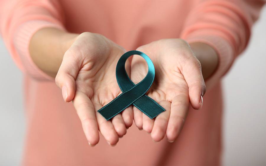 Woman holding ovarian cancer awareness symbol.