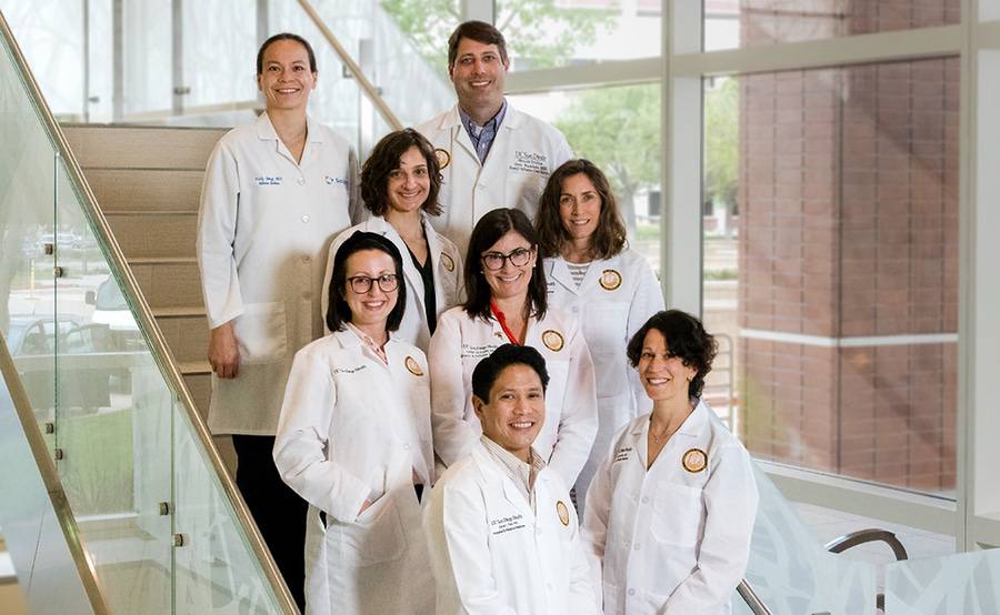 Faculty and fellows of the UCSD/Scripps Health Hospice and Palliative Medicine Fellowship Program stand on a stairway.
