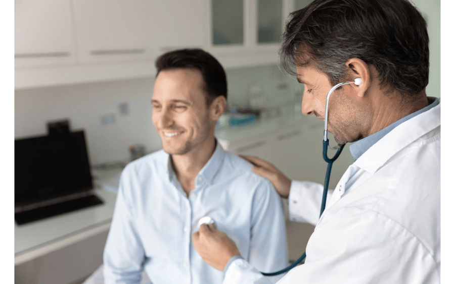 A patient meets with his doctor after signing up for new insurance plan during open enrollment.