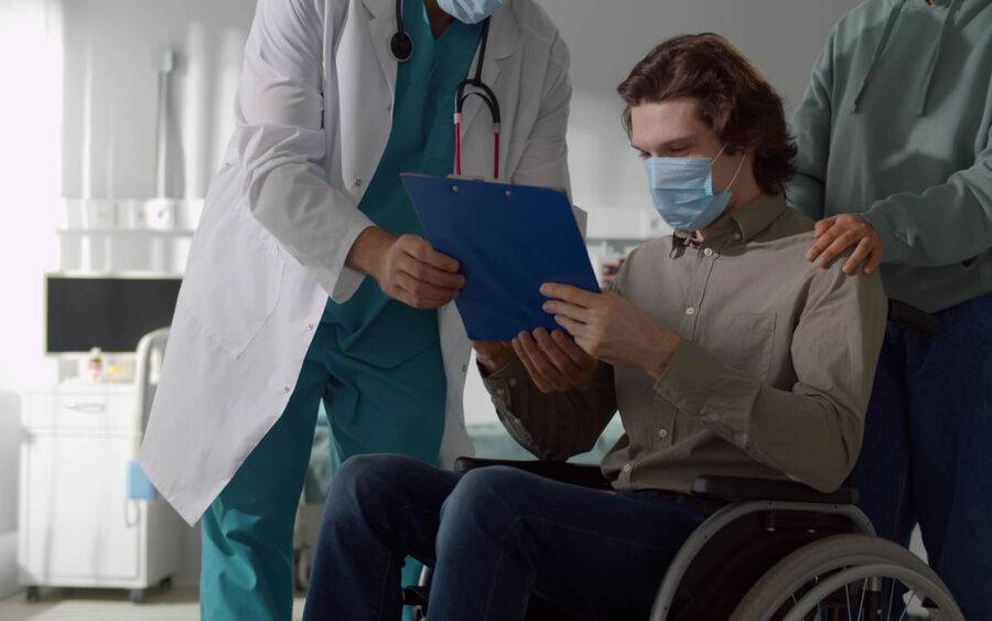 A patient is given his discharge papers to follow and to avoid hospital readmission.