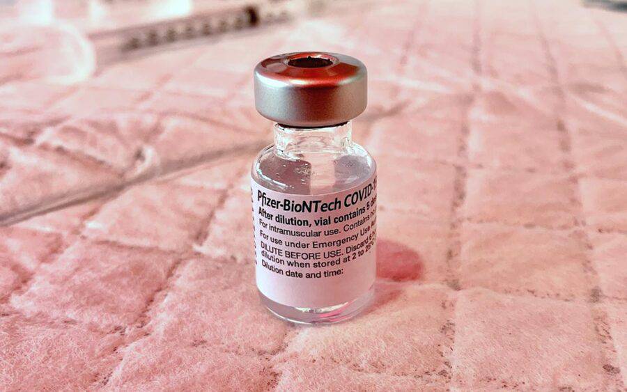 A vial of the Pfizer-BioNTech COVID-19 vaccine sits on a medical absorbant pad.