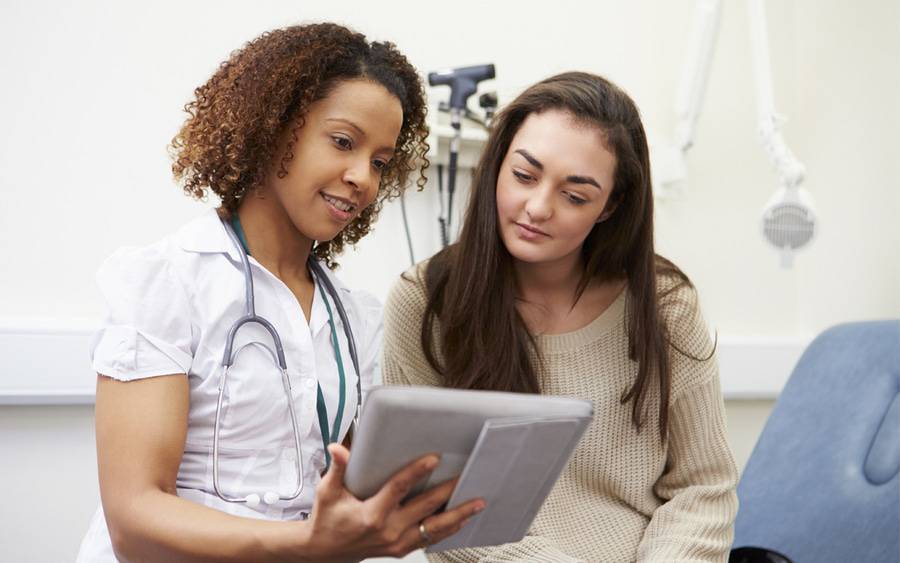 A health care provider and patient discuss menstrual cramping and go over test results.