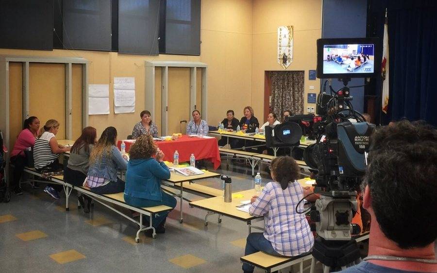 Members of the Scripps Dulce Diabetes Program gather in a room for a PBS NewsHour feature taping.