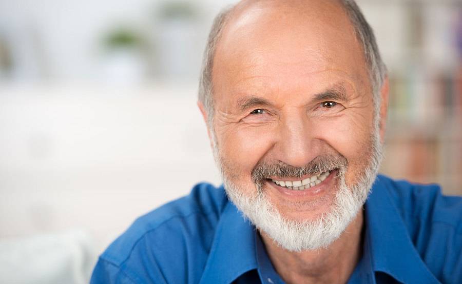 A smiling mature man represents the full life that can be led after prostate cancer treatment.