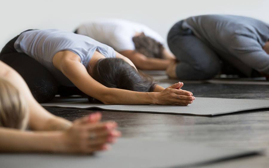 people in yoga pose in a class