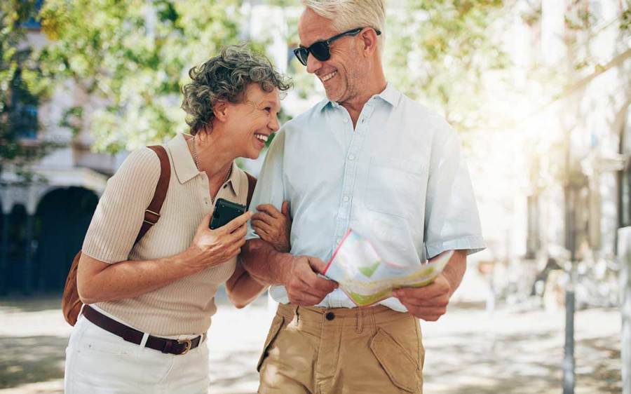 A happy retired couple traveling.