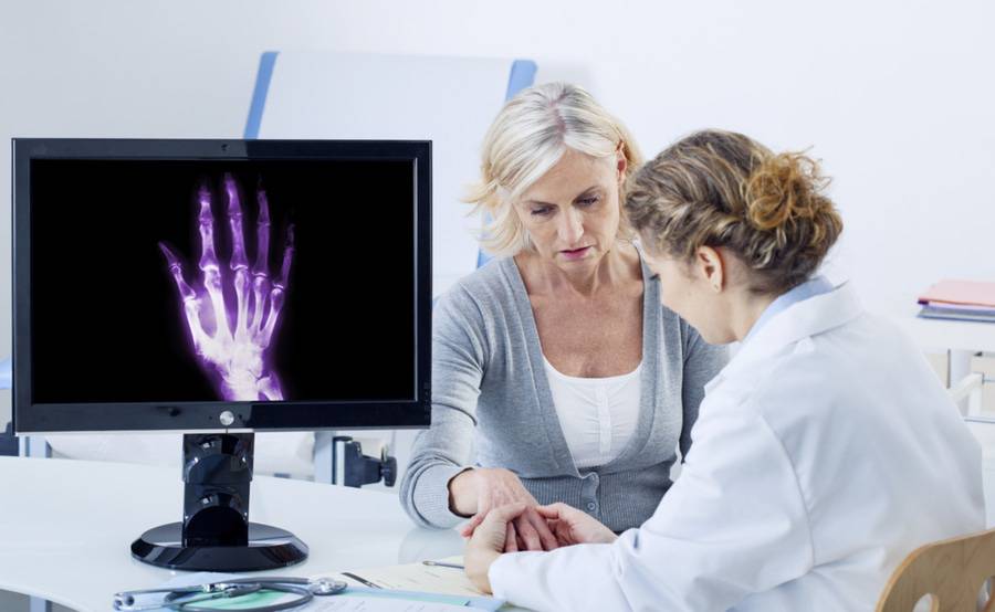 Rheumatology fellow consults with a patient.
