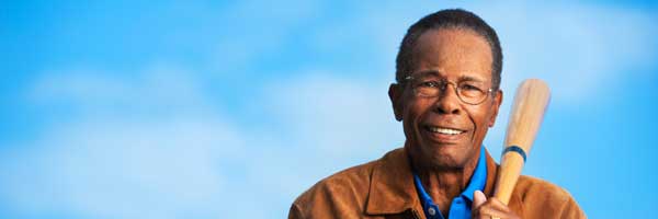Scripps heart care patient Rod Carew holds a baseball bat.