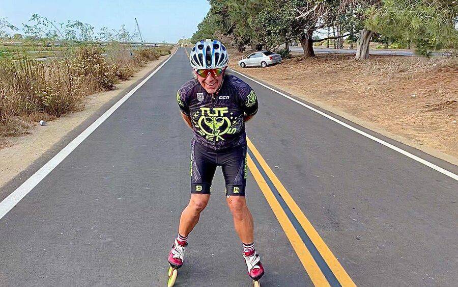 National inline skating champion Roger Olson skates down a two-lane road after heart valve surgery.