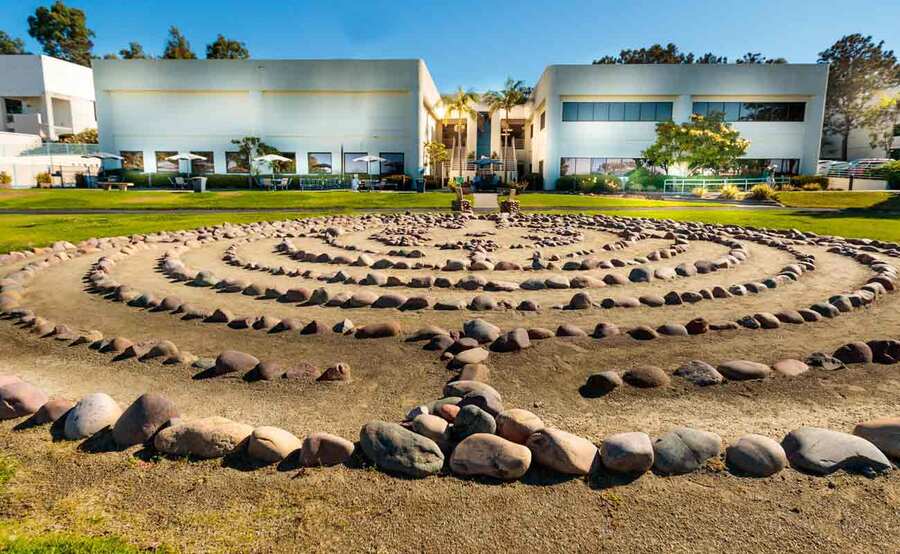 A labyrinth made of stone on the ground behind the Shiley Fitness Center at Scripps Center for Integrative Medicine.
