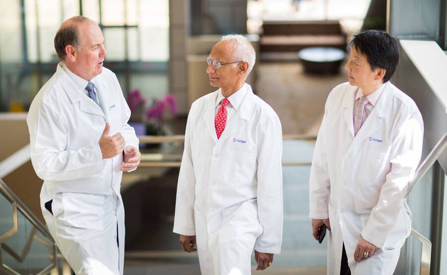 A group of radiation oncologists in discussion represents the team of cancer experts who will care for you at Scripps.