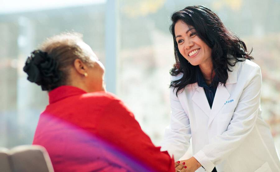 A Scripps Cancer Center oncology nurse navigator shares a warm moment with a cancer patient.