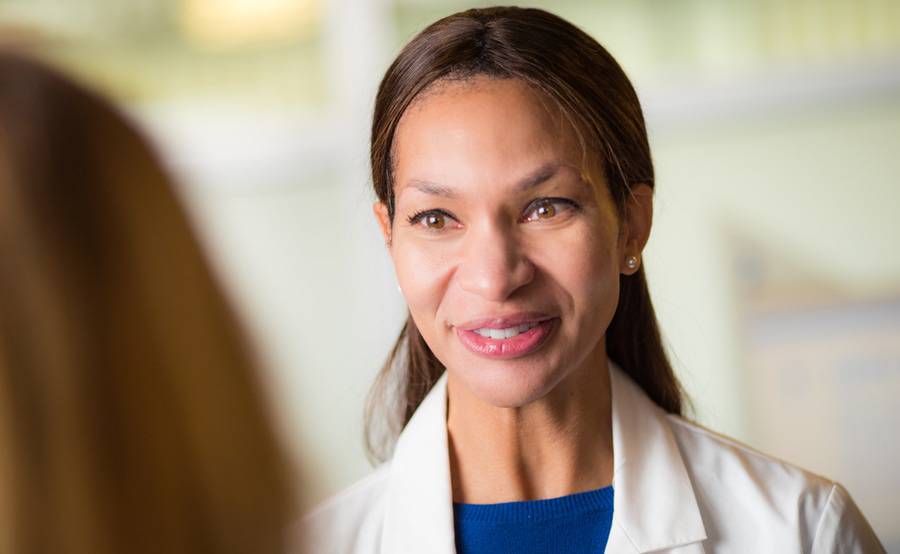 Internal medicine doctor Rio Dickens-Celestin, MD, talks with a patient, representing the high-quality primary care at Scripps Clinic and Scripps Coastal.