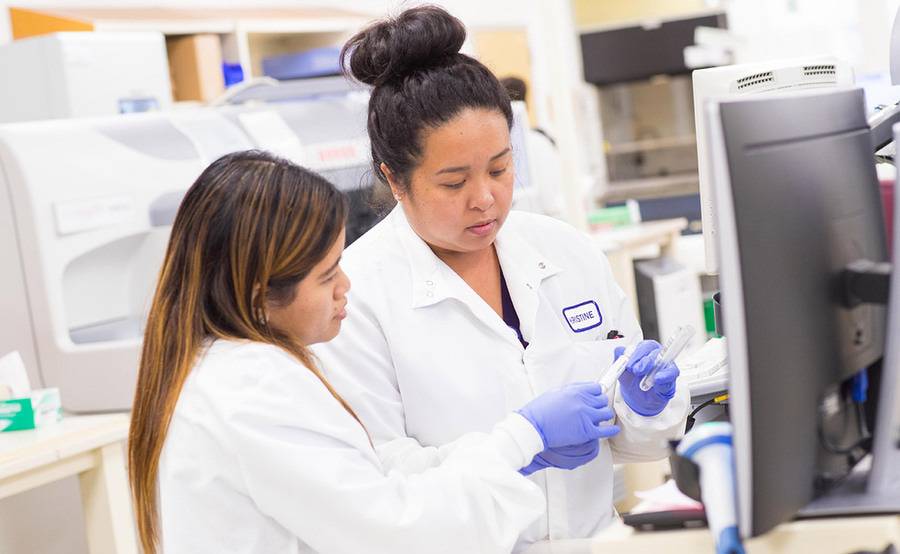 Two Scripps lab scientists review a specimen, representing the CLS training program at Scripps.