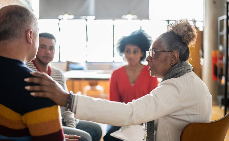 People of various ethnic backgrounds in a group setting represent the Scripps Collaborative for Health Equity..