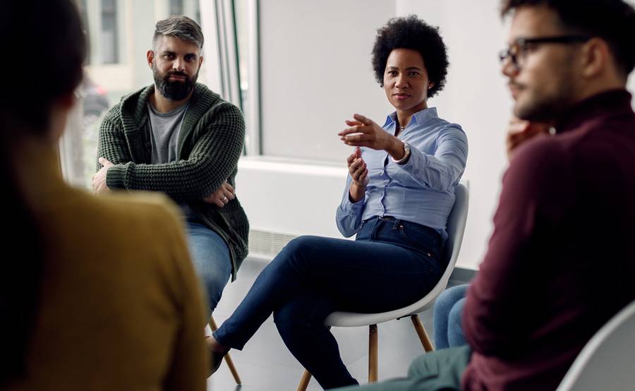 A black person in a group setting represents expanded community interventions and programs for multicultural populations.