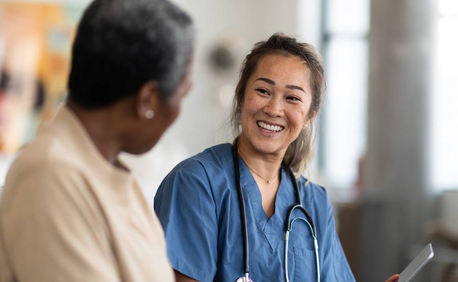 An Asian health care worker and black person represent improved access to culturally appropriate health care resources.